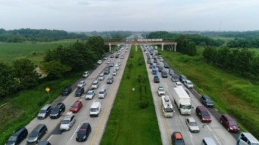 Para pemudik duduk di Stasiun Senen, Jakarta, menanti kereta api yang akan membawa mereka pulang ke kampung halaman mereka, 28 April 2022.